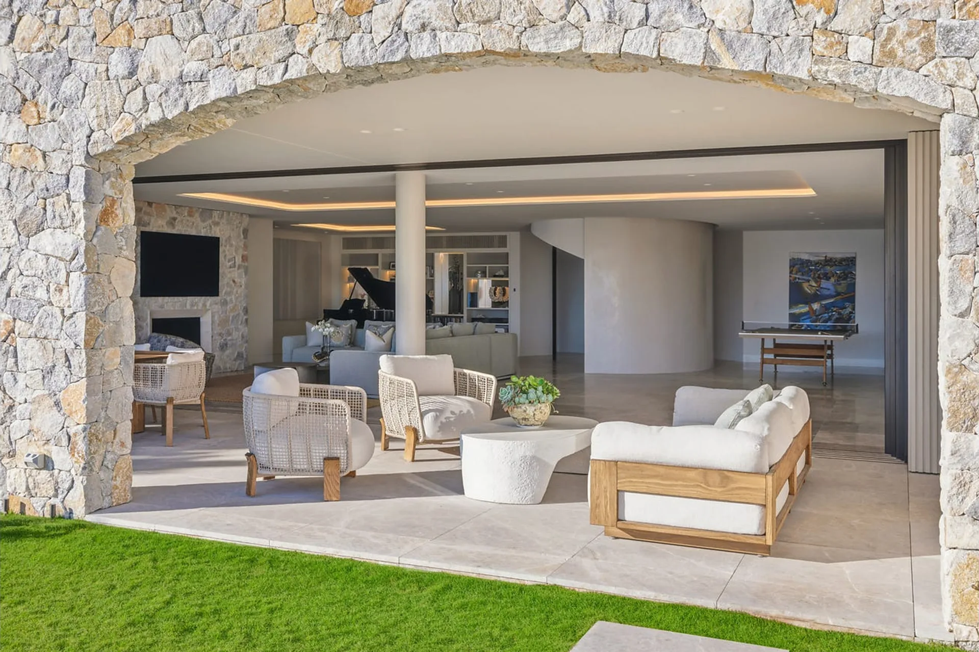Bayview Hill Road, Rose Bay - stone arch opening from the lawn into the living area