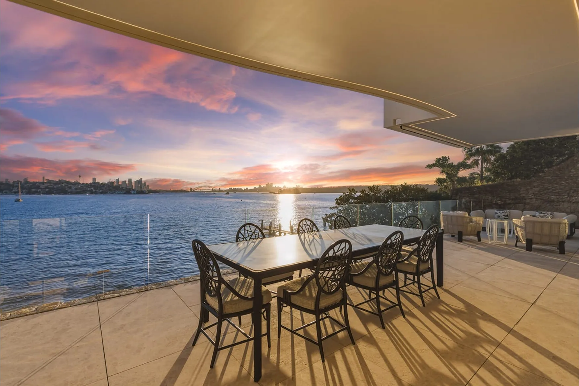Bayview Hill Road, Rose Bay - harbourfront terrace at sunset, city skyline and Harbour Bridge beyond