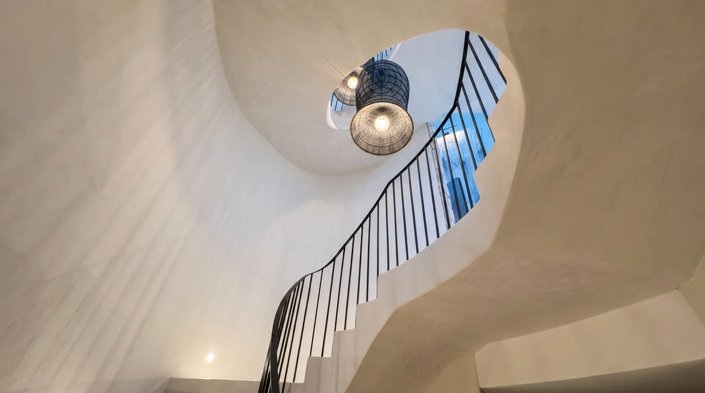 Clairvaux Road, Vaucluse - sculptural microcement staircase and curved wall beneath the skylight